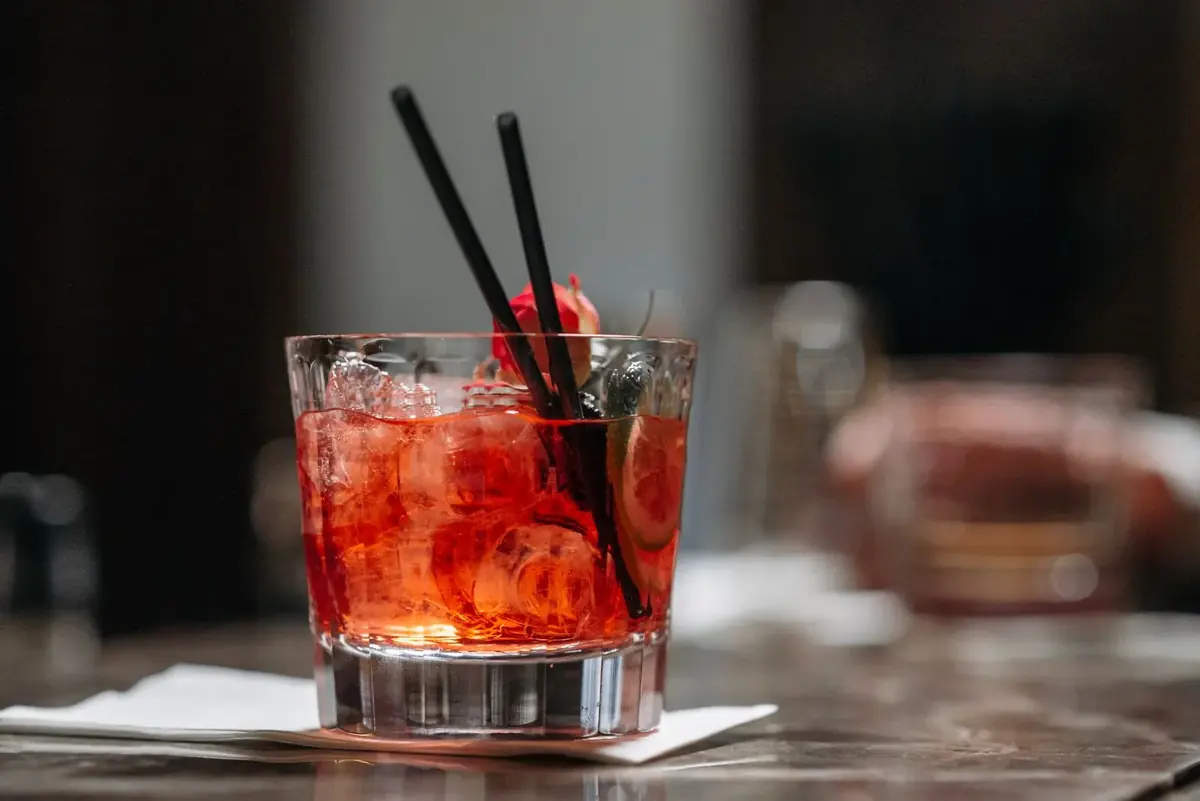A Negroni-style red cocktail on a bar counter