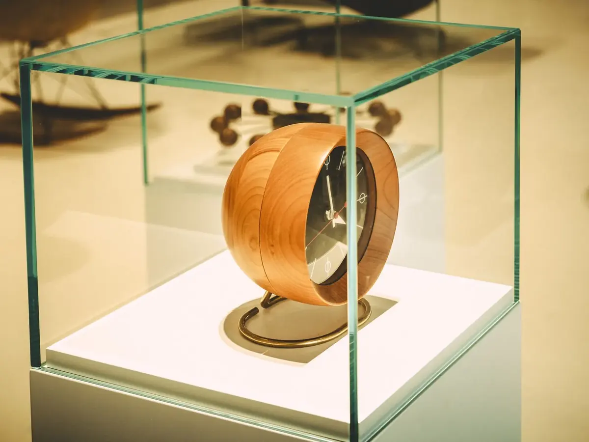 A design object displayed in a glass case