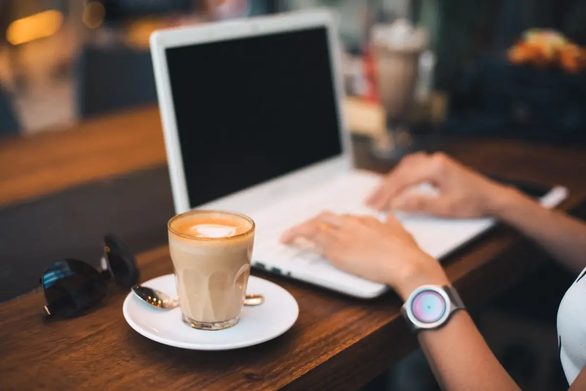 Laptop and latte on a café table