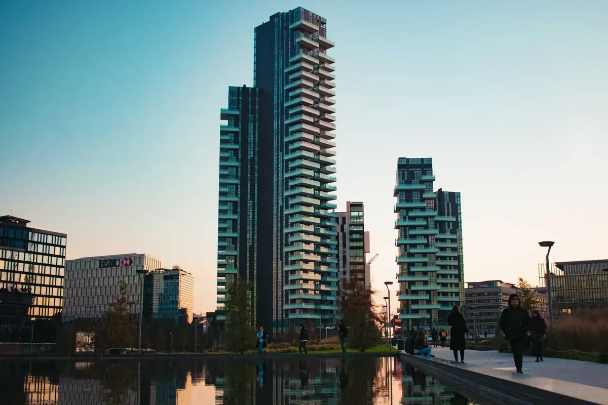 Porta Nuova towers reflected in water at dusk
