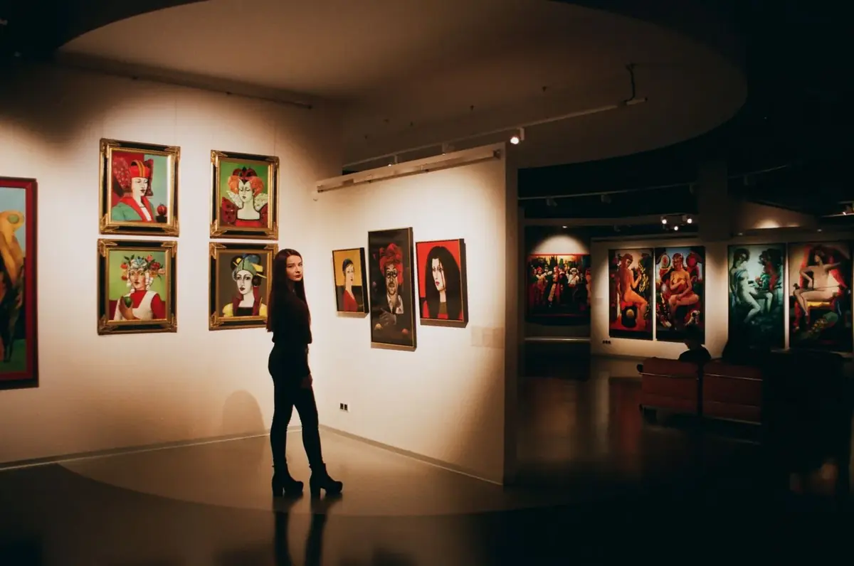 A visitor looking at paintings in a gallery