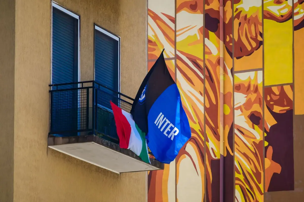 An Inter flag hanging from a balcony