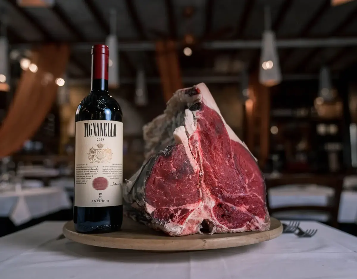 Dry-aged beef presented with a bottle of red wine